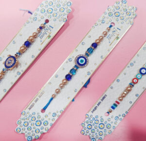 esmi-evil-eye-rakhi-studded-rakhi.jpg Esmi?- *Evil Eye Rakhi- Studded Rakhi*