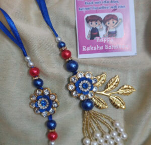 esmi-flower-studded-rakhi-lumba-set.jpg Esmi?- *Flower Studded Rakhi & Lumba set*